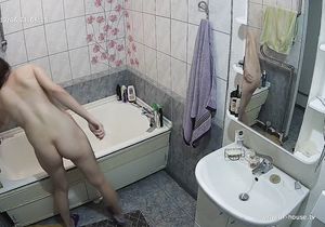 Nude gal checks her ass and pussy solo in bathroom