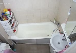 Brunette carefully washes herself in the afternoon