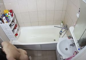 Brunette carefully washes herself in the afternoon