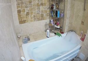 Chick prepares bubble bath not knowing about hidden cam