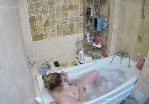 Chick prepares bubble bath not knowing about hidden cam