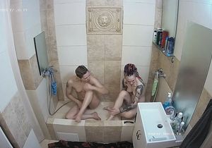 Inked hottie relaxes in the shower with blonde GF