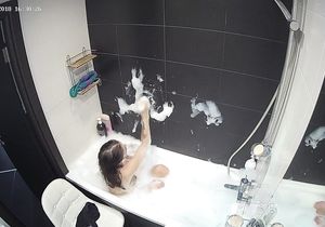 Petite roommate fools around solo in bubble bath