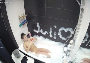 Petite roommate fools around solo in bubble bath
