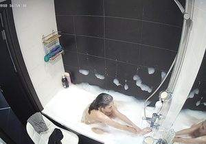 Petite roommate fools around solo in bubble bath