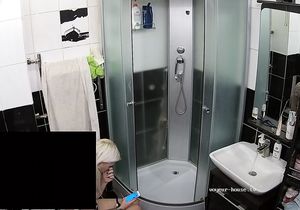 Small-tittied chick sits on toilet bowl before shower