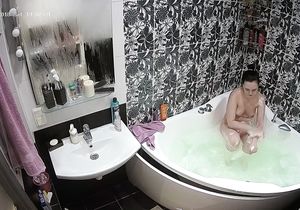 Hidden camera captures naked chick in bathroom