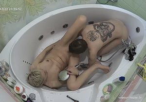 Ceiling camera films blonde and servant in bathroom