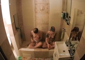 Tattooed girls save water taking shower together