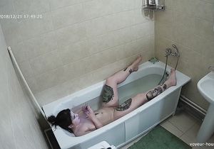 Tattooed brunette takes a bath on my hidden camera