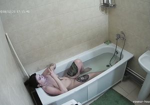 Tattooed brunette takes a bath on my hidden camera