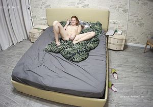 Redhead ostentatiously inserts sex toy in vagina